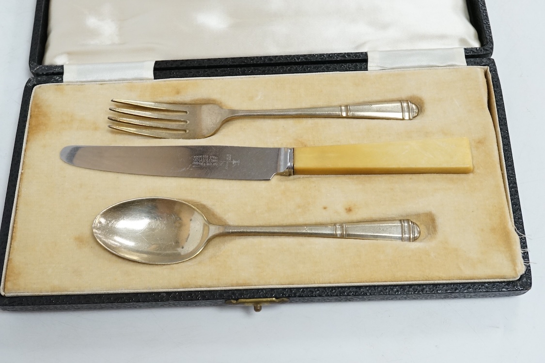 Three assorted silver christening sets including spoon, fork and napkin ring by William Hutton & Sons, London, 1896, one other set with steel knife, two cased sets of silver coffee spoons and a cased set of six Japanese